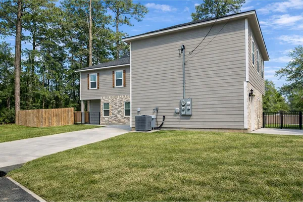 a view of a house with a yard and a patio