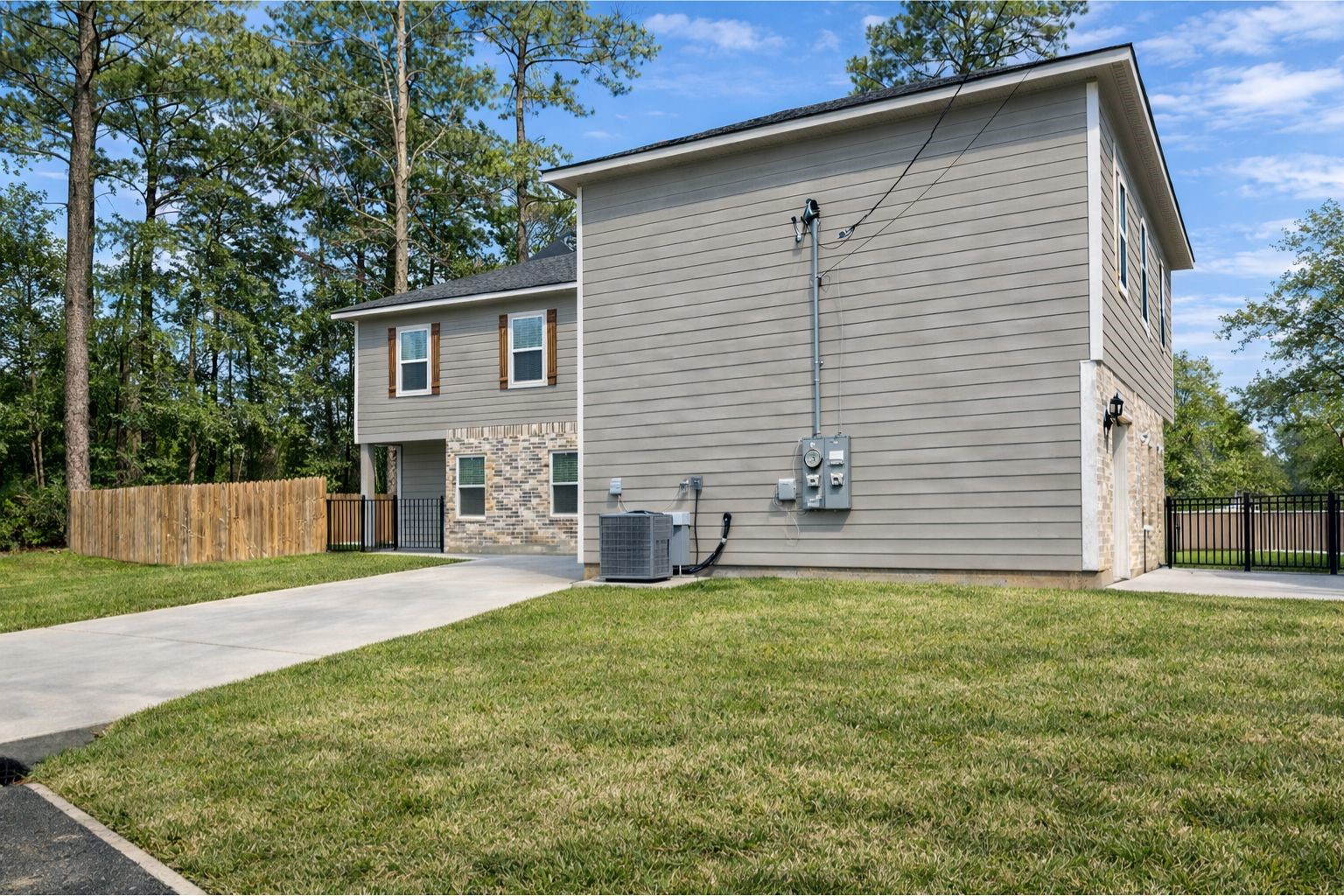 1100 Mann Road Conroe, TX 77303 - Photo 3 of 16 a view of a house with a yard and a patio
