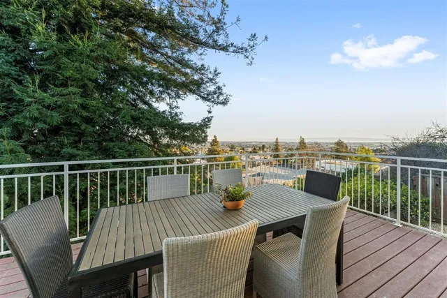 a view of a house with backyard and deck