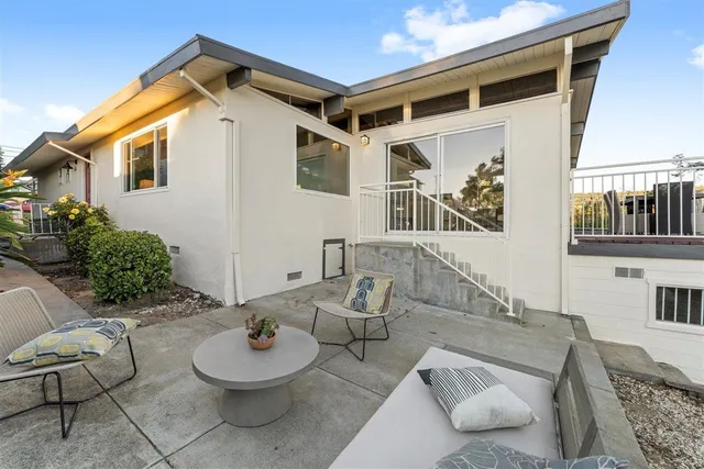 a view of a pathway of a house with a yard