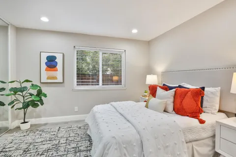 a bedroom with a bed and a couch