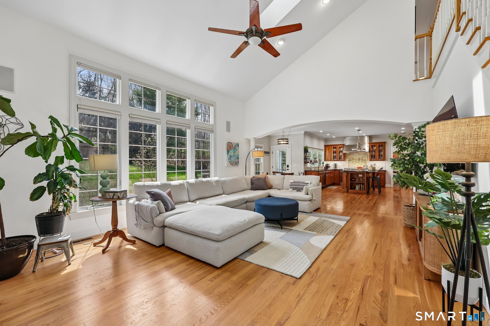 3 East Lake Road Danbury, CT 06811 - Photo 18 of 37 The family room impresses with a soaring ceiling and a dramatic wall of windows that flood the space with natural light while drawing the backyard beautifully into view.
