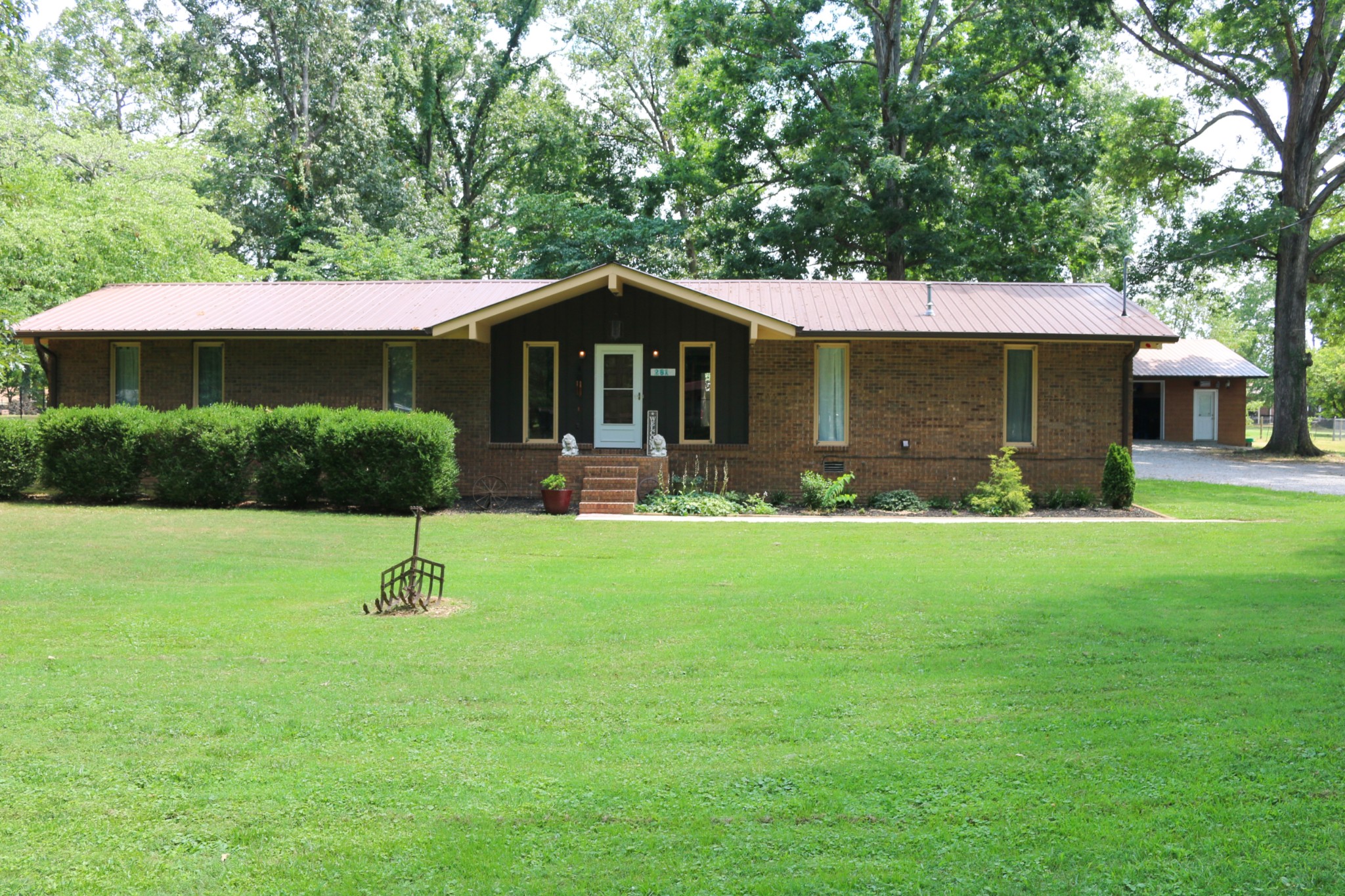 a front view of house with a garden