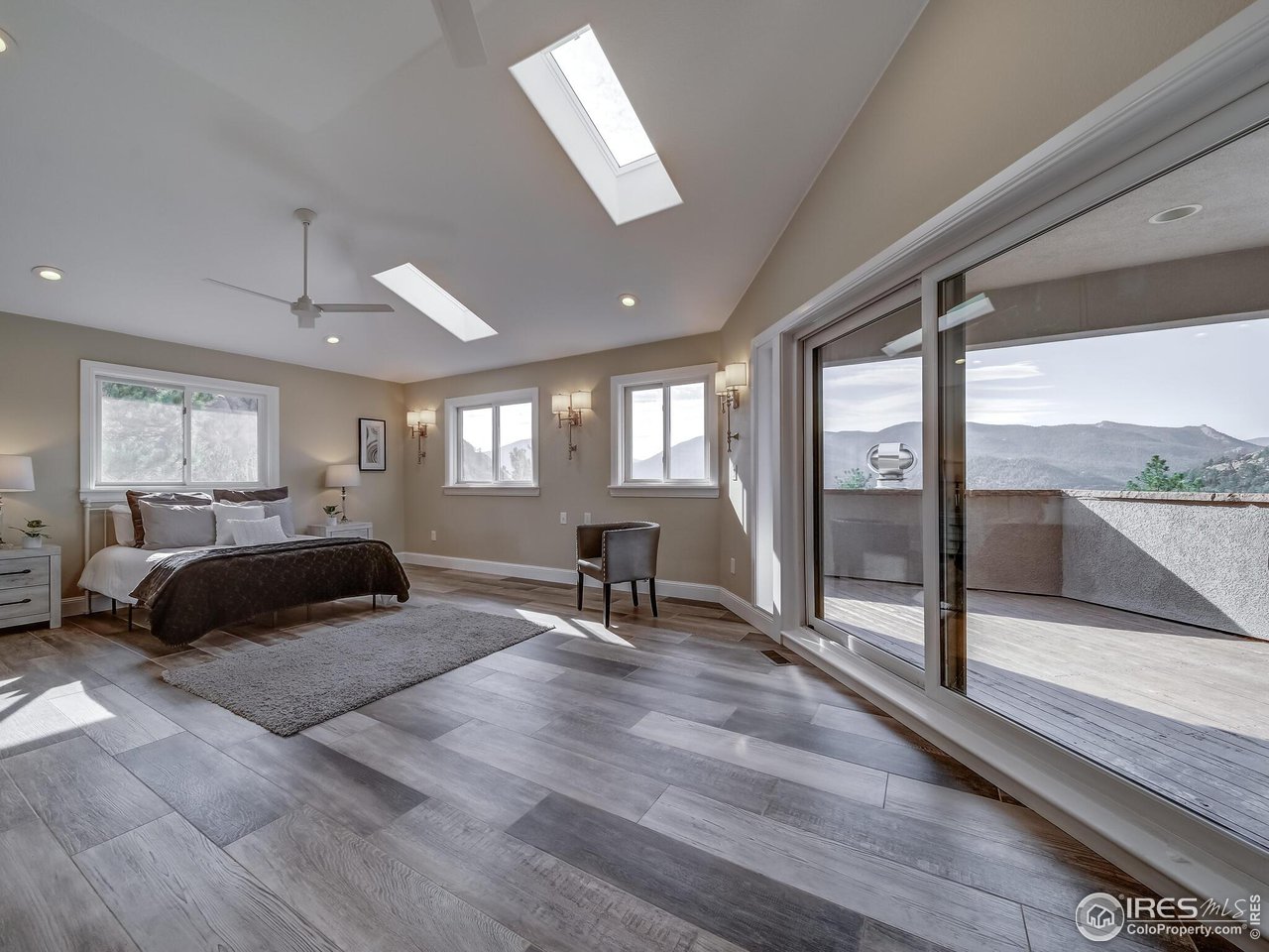 5634 Longmont Dam Road Lyons, CO 80540 - Photo 14 of 34 a bedroom with a bed and a large window