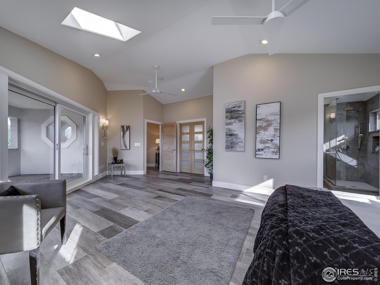 5634 Longmont Dam Road Lyons, CO 80540 - Photo 15 of 34 a spacious bedroom with a bed and a large mirror