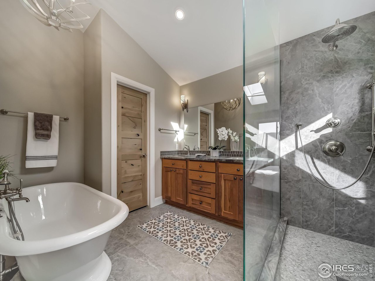 5634 Longmont Dam Road Lyons, CO 80540 - Photo 16 of 34 a spacious bathroom with a tub sink and mirror