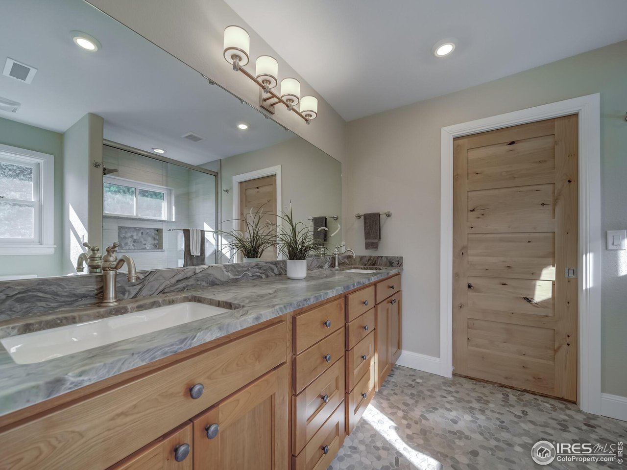 5634 Longmont Dam Road Lyons, CO 80540 - Photo 19 of 34 a bathroom with a granite countertop sink a mirror and a shower