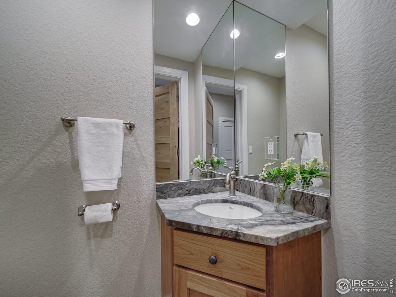 5634 Longmont Dam Road Lyons, CO 80540 - Photo 25 of 34 a bathroom with a granite countertop sink and a mirror