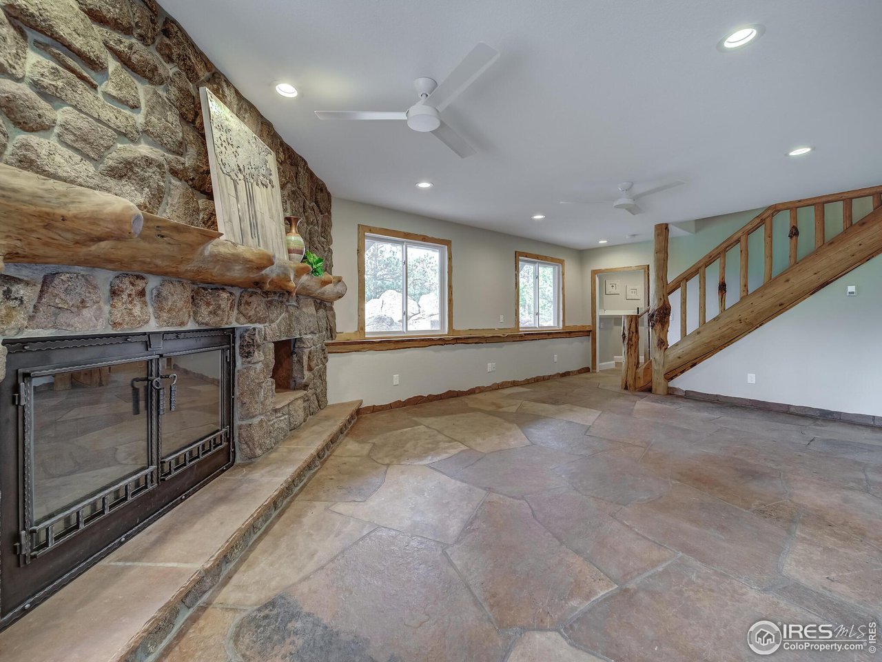 5634 Longmont Dam Road Lyons, CO 80540 - Photo 27 of 34 a view of an empty room with a fireplace and a window