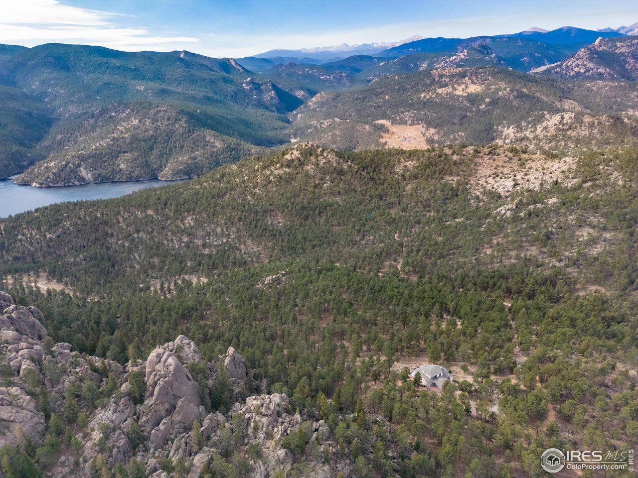 5634 Longmont Dam Road Lyons, CO 80540 - Photo 31 of 34 a view of a house with a mountain