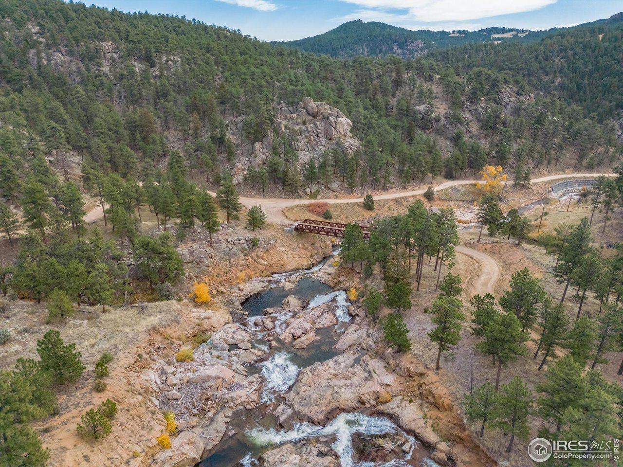 5634 Longmont Dam Road Lyons, CO 80540 - Photo 33 of 34 a view of a forest with a lake