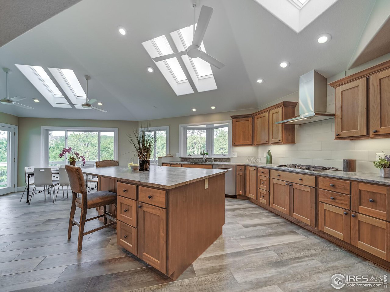 5634 Longmont Dam Road Lyons, CO 80540 - Photo 7 of 34 a kitchen with stainless steel appliances granite countertop a table chairs sink and cabinets
