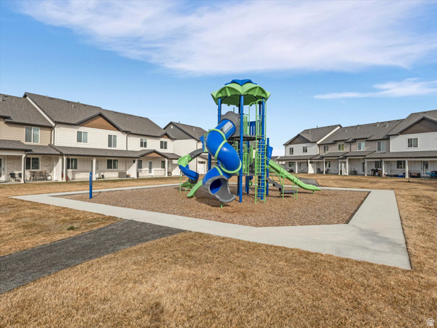 3047 Old Emigrant Road, Unit C Syracuse, UT 84075 - Photo 17 of 20 Communal playground featuring a residential view and a lawn