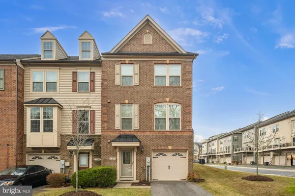 a front view of a residential apartment building with a yard