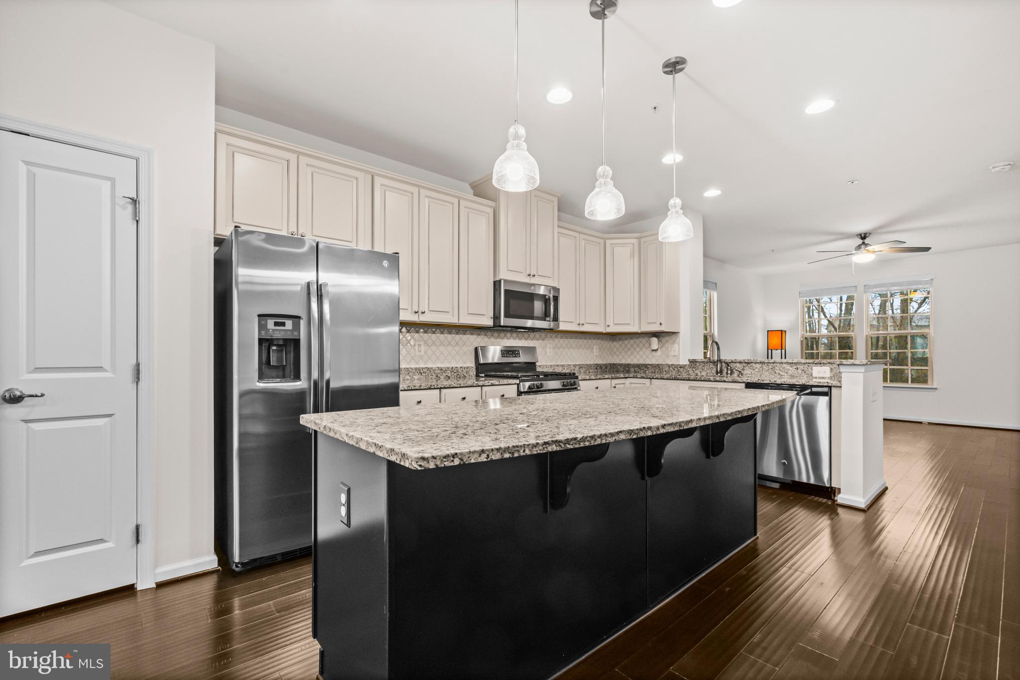 7839 Patterson Way Hanover, MD 21076 - Photo 16 of 56 a kitchen with stainless steel appliances granite countertop a sink stove and refrigerator