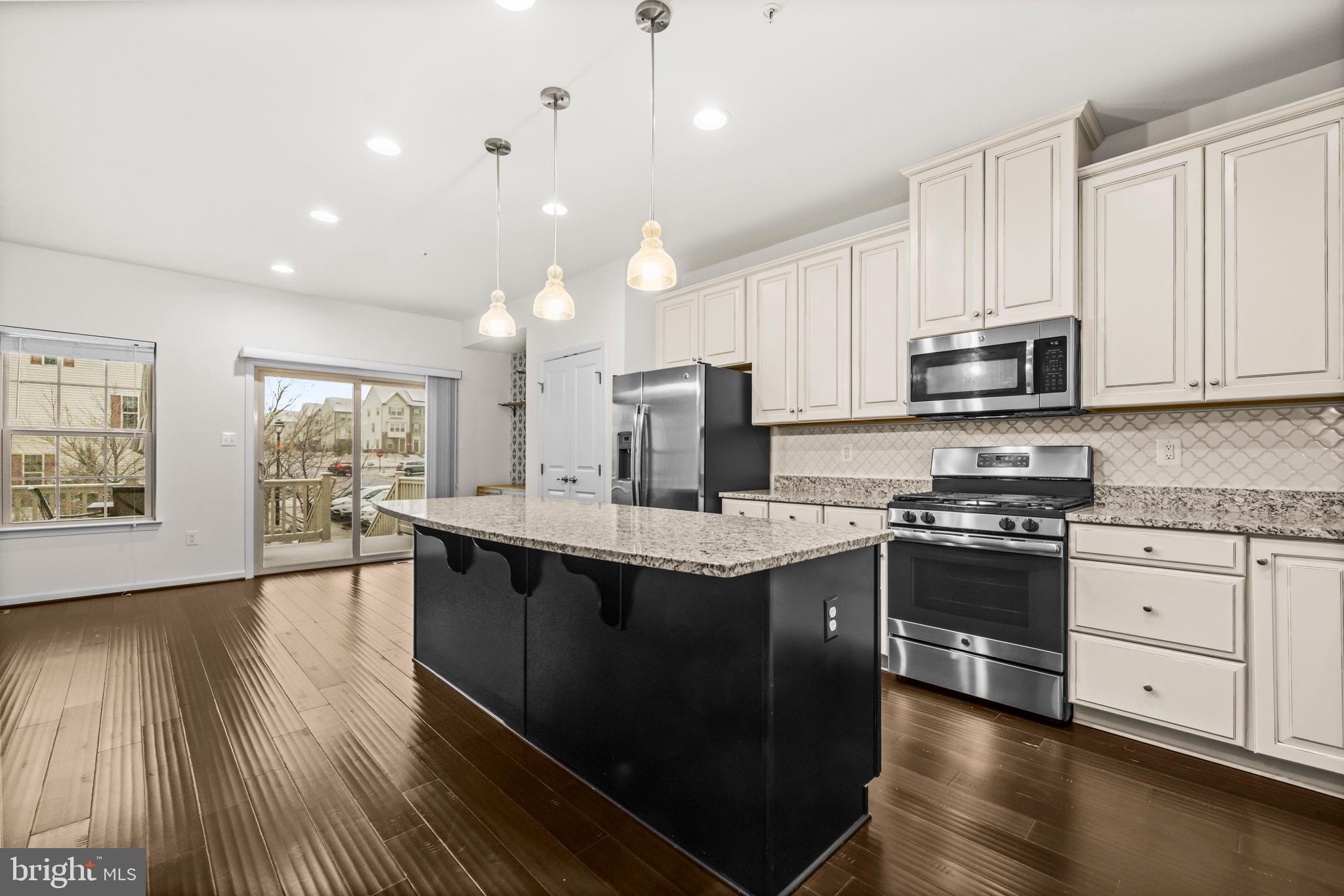 7839 Patterson Way Hanover, MD 21076 - Photo 18 of 56 a kitchen with stainless steel appliances granite countertop a stove and a sink