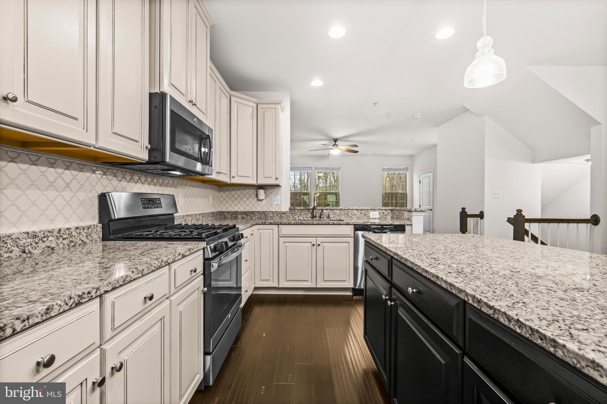 7839 Patterson Way Hanover, MD 21076 - Photo 20 of 56 a kitchen with granite countertop sink stainless steel appliances and white cabinets
