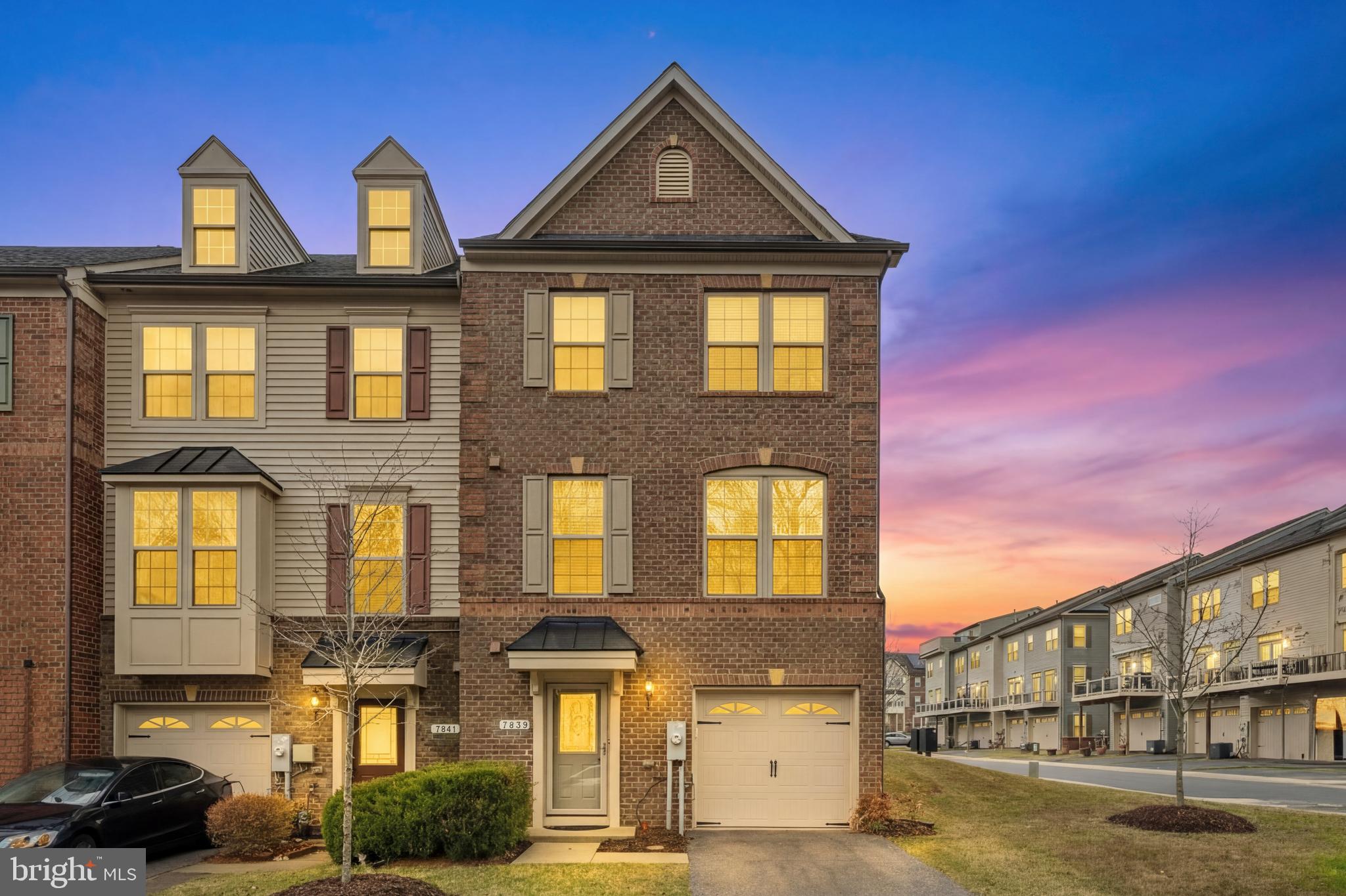 7839 Patterson Way Hanover, MD 21076 - Photo 2 of 56 a front view of a residential apartment building with a yard
