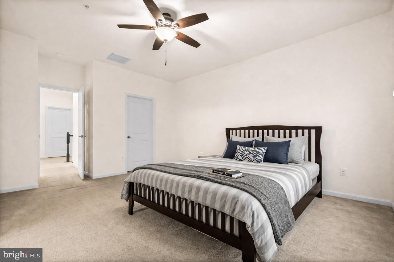 7839 Patterson Way Hanover, MD 21076 - Photo 31 of 56 a bedroom with a bed and a ceiling fan