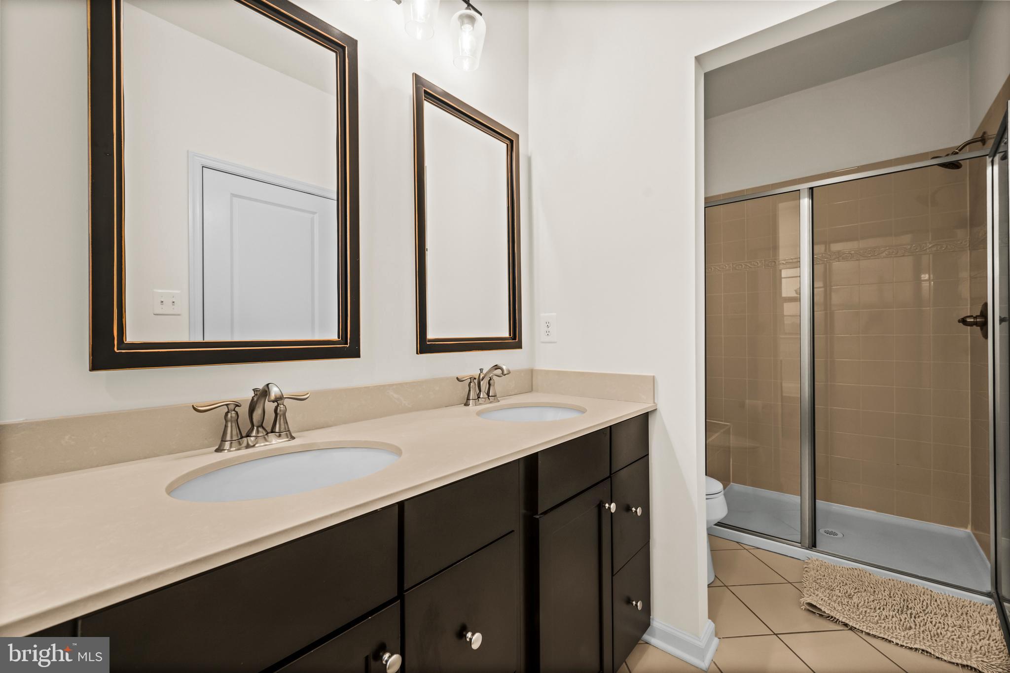 7839 Patterson Way Hanover, MD 21076 - Photo 34 of 56 a bathroom with a double vanity sink mirror and shower