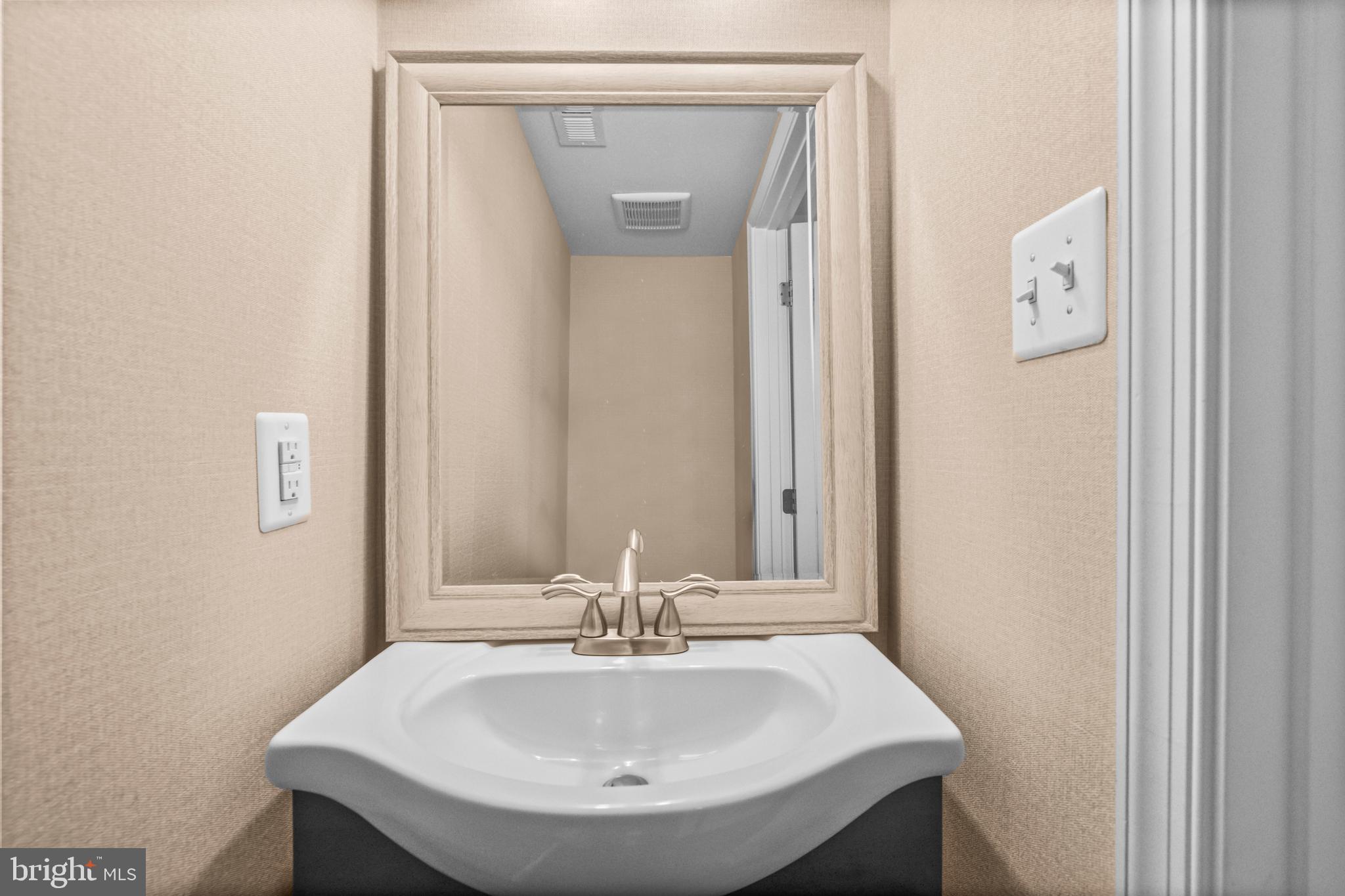 7839 Patterson Way Hanover, MD 21076 - Photo 35 of 56 a bathroom with a sink and a mirror