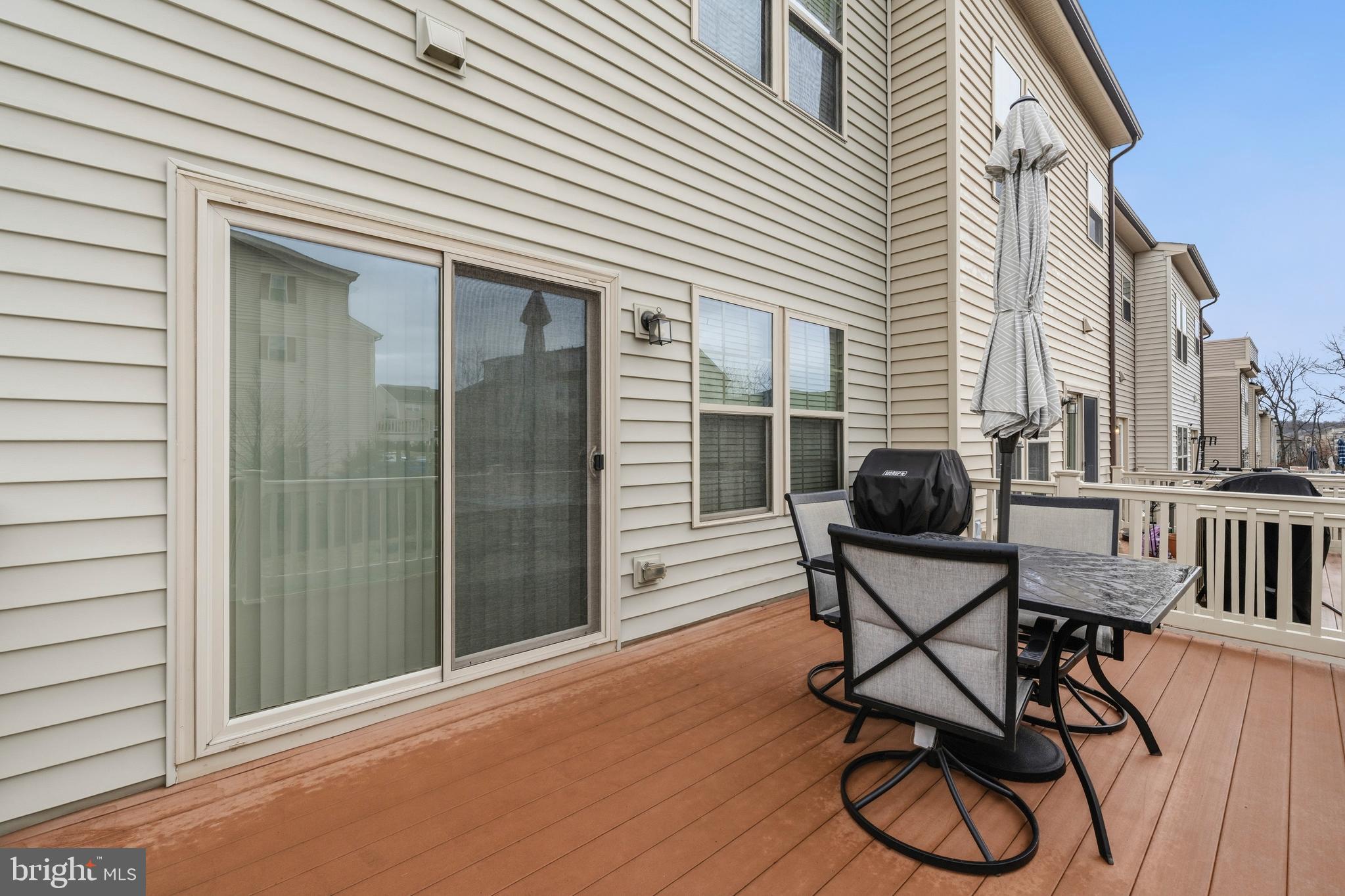 7839 Patterson Way Hanover, MD 21076 - Photo 40 of 56 a patio with table and chairs and potted plants