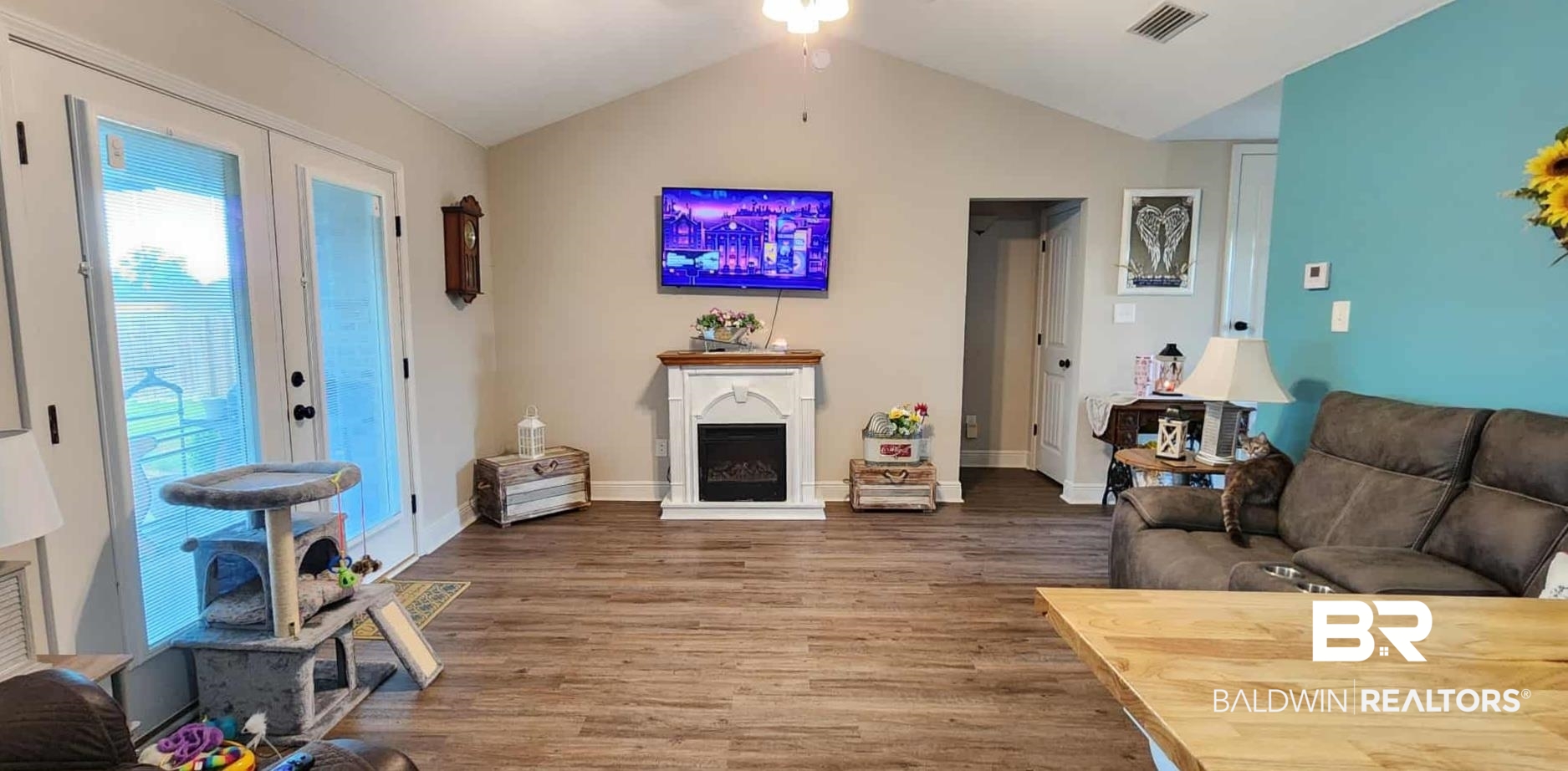 15623 Medway Court Foley, AL 36535 - Photo 12 of 29 Living area featuring lofted ceiling, a fireplace, wood finished floors, and french doors