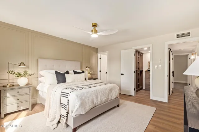 a bedroom with a bed and a chandelier