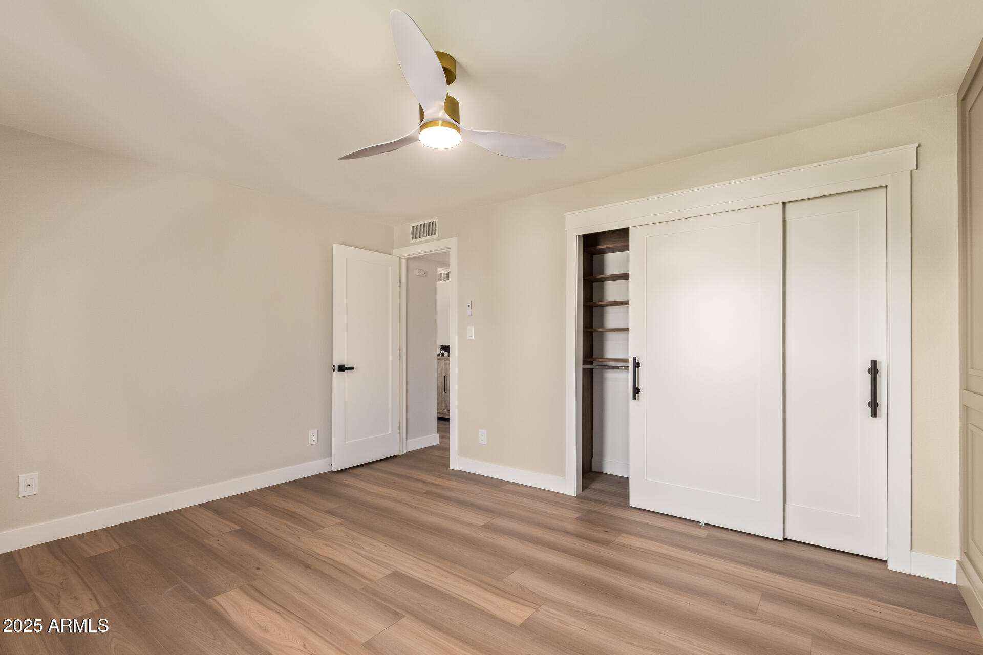 4201 East Camelback Road, Unit 14 Phoenix, AZ 85018 - Photo 18 of 26 a view of an empty room with wooden floor