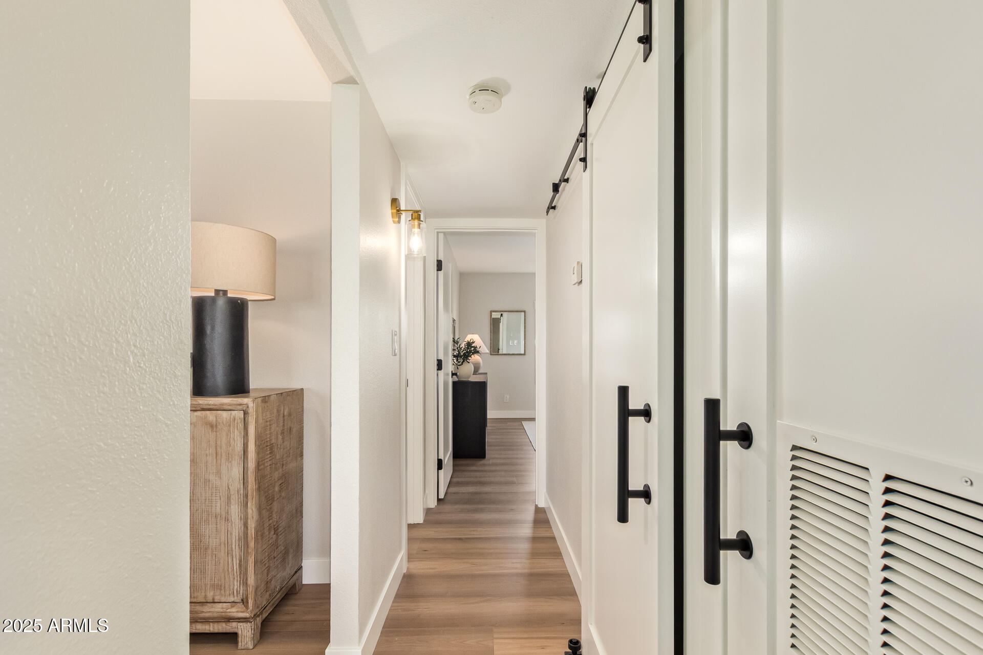 4201 East Camelback Road, Unit 14 Phoenix, AZ 85018 - Photo 20 of 26 a view of a hallway with wooden floor and staircase