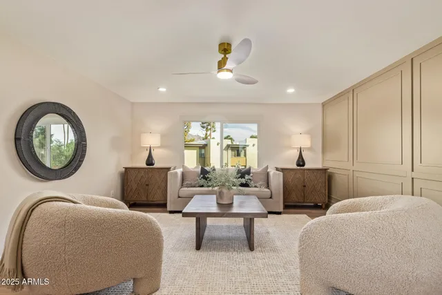 a living room with furniture a chandelier and a large window