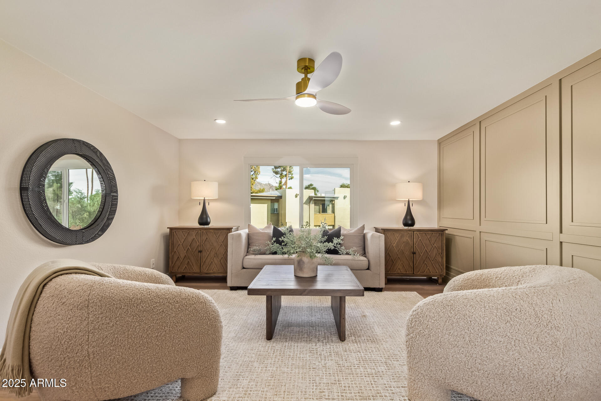 4201 East Camelback Road, Unit 14 Phoenix, AZ 85018 - Photo 3 of 26 a living room with furniture a chandelier and a large window