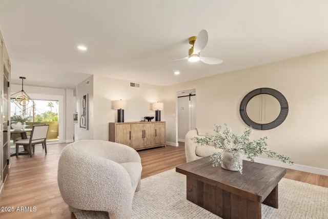 a living room with furniture a dining table and a fireplace