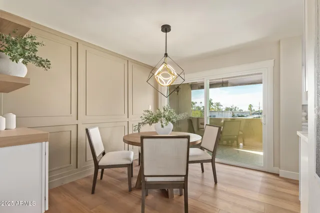 a dining room with furniture window and wooden floor