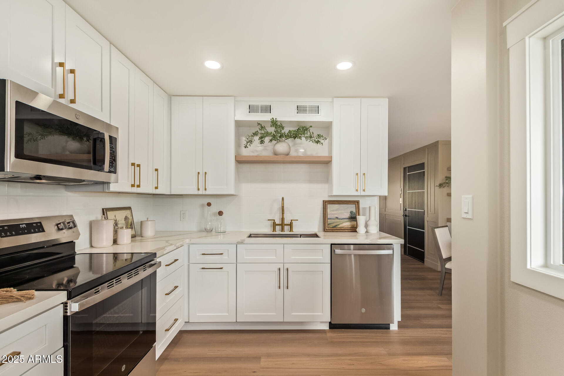 4201 East Camelback Road, Unit 14 Phoenix, AZ 85018 - Photo 10 of 26 a kitchen with stainless steel appliances white cabinets and a stove top oven