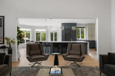 a kitchen area with stainless steel appliances granite countertop a stove a sink and a microwave