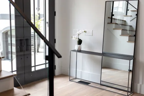 a living room with furniture a rug and a large window