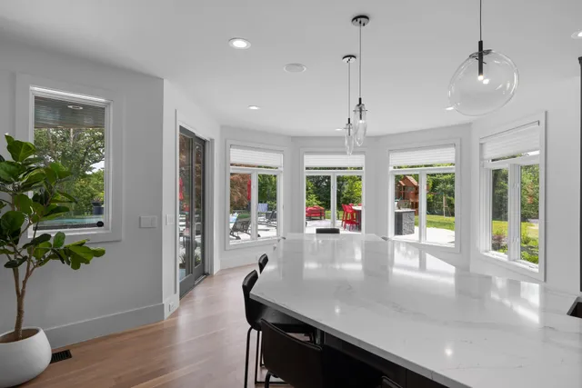a view of a house with swimming pool and furniture
