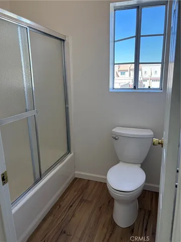 a view of hallway with wooden floor