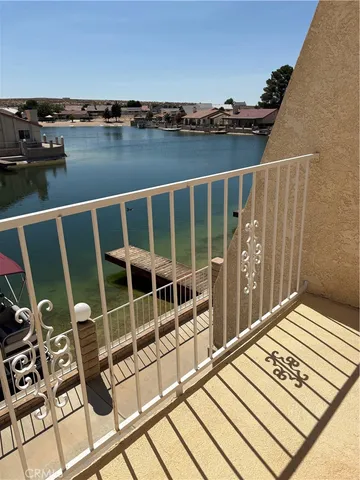a view of a livingroom with wooden floor and a fireplace