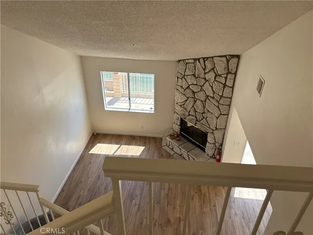 a bathroom with a granite countertop toilet sink and mirror
