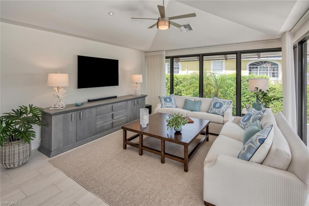 159 Conners Avenue Naples, FL 34108 - Photo 14 of 35 a living room with furniture and a flat screen tv