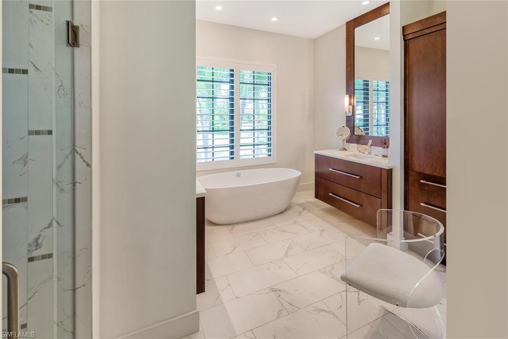 159 Conners Avenue Naples, FL 34108 - Photo 22 of 35 a bathroom with a tub sink and mirror