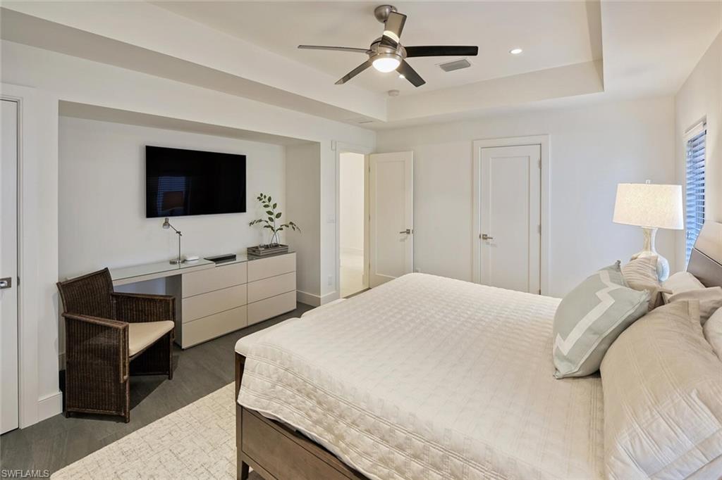 159 Conners Avenue Naples, FL 34108 - Photo 27 of 35 a bedroom with a bed and a flat screen tv
