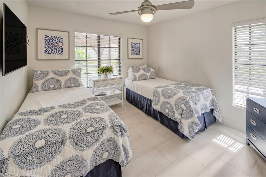159 Conners Avenue Naples, FL 34108 - Photo 29 of 35 a bedroom with a bed couch and window
