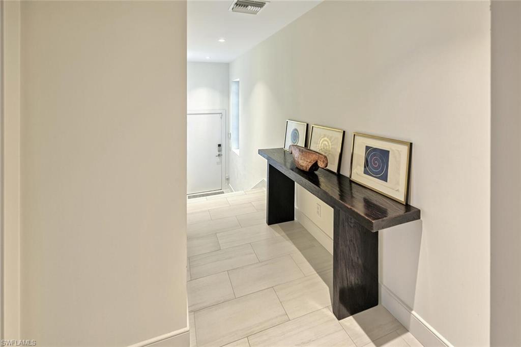 159 Conners Avenue Naples, FL 34108 - Photo 32 of 35 a view of a hallway with workspace