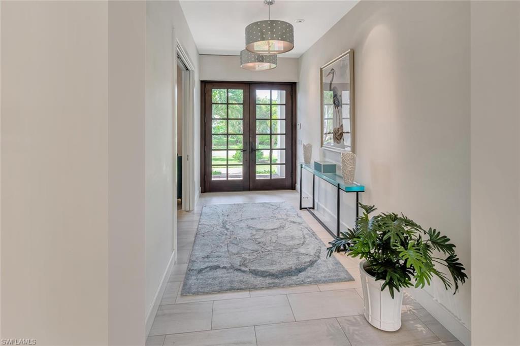 159 Conners Avenue Naples, FL 34108 - Photo 9 of 35 wooden floor in an empty room with a window