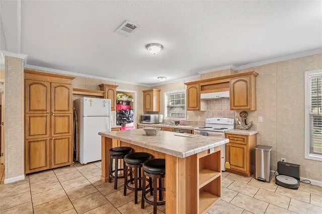 a kitchen with stainless steel appliances granite countertop a stove and a refrigerator