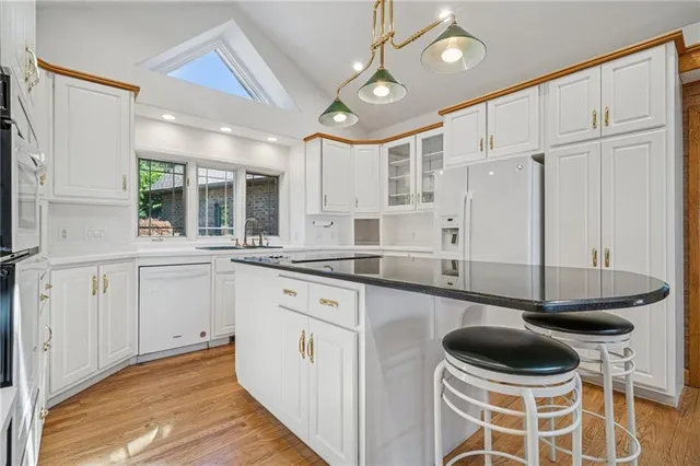 a kitchen with a sink cabinets and window