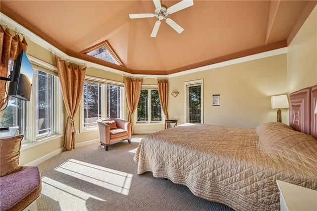 a spacious bedroom with a bed and a chandelier